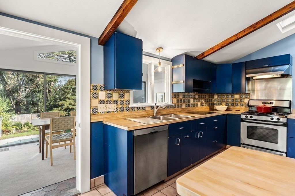 7 Circle Street Marblehead, MA 01945 - Photo 11 of 36 a kitchen with stainless steel appliances granite countertop a sink counter space and a large window
