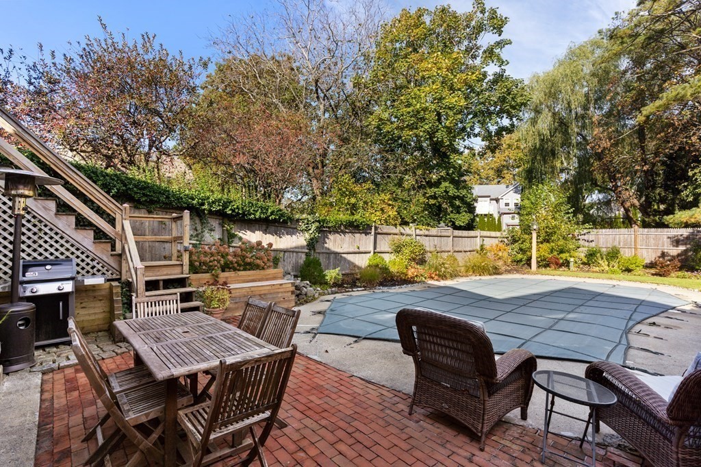 7 Circle Street Marblehead, MA 01945 - Photo 25 of 36 a view of a roof deck with table and chairs with wooden floor and fence