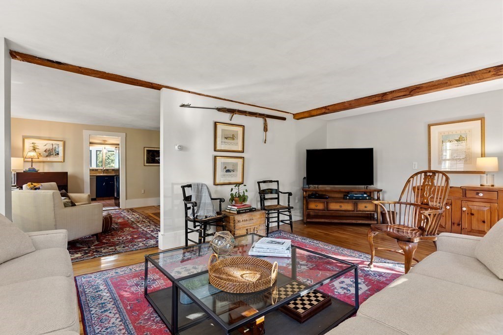 7 Circle Street Marblehead, MA 01945 - Photo 3 of 36 a living room with furniture a flat screen tv and kitchen view