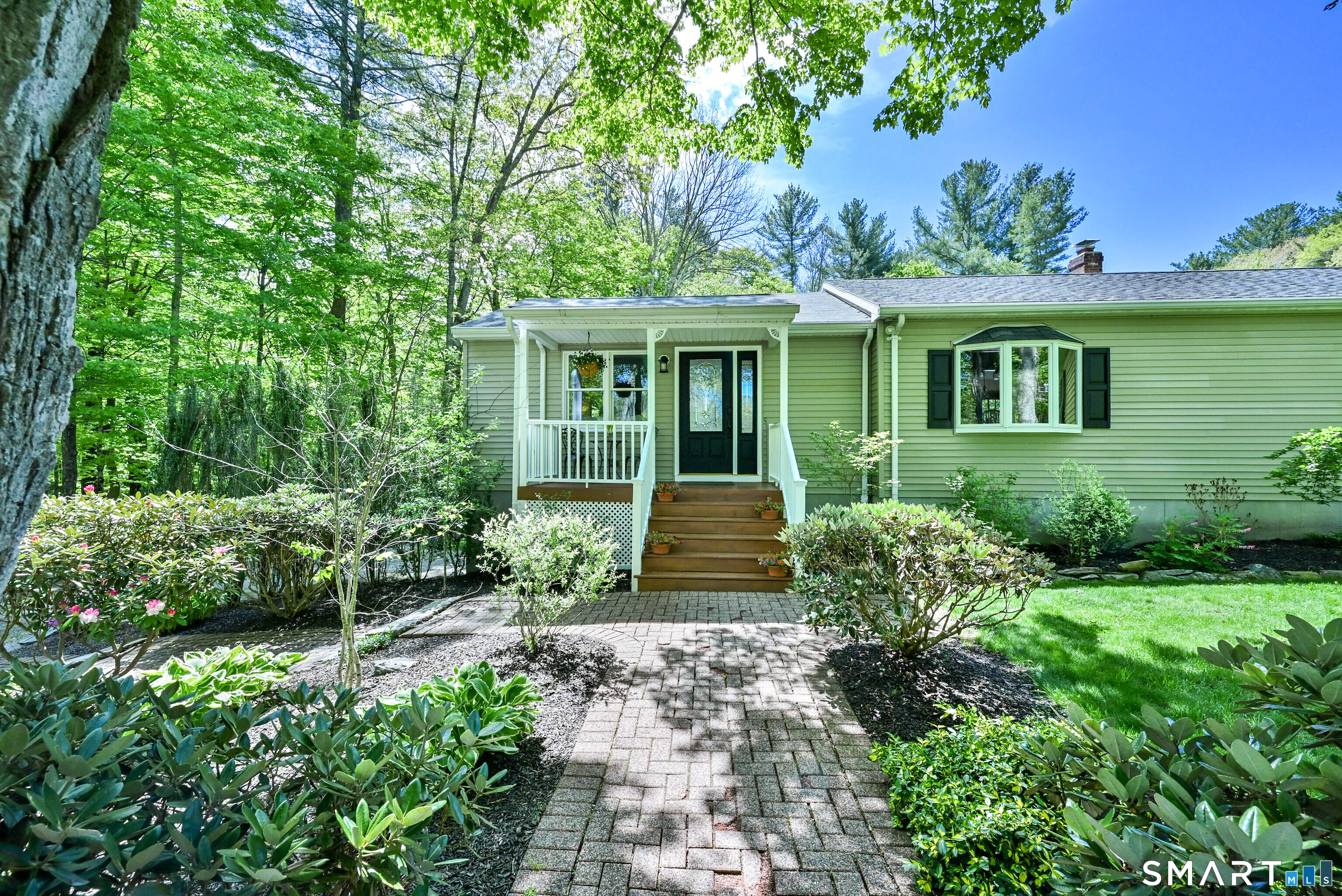 309 O'Leary Road Thompson, CT 06277 - Photo 7 of 40 a front view of a house with a garden