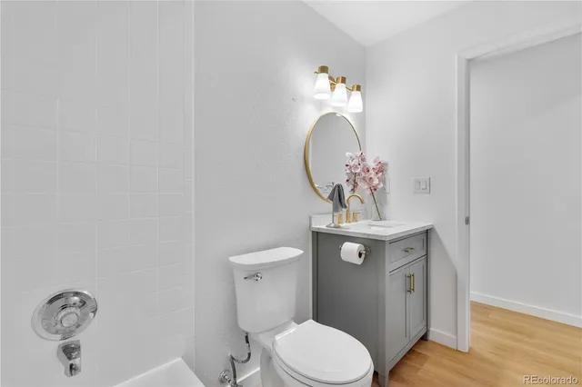 a bathroom with a toilet a sink and a mirror