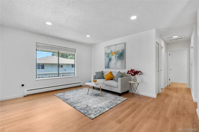 a view of a deck with couches with wooden floor and fence