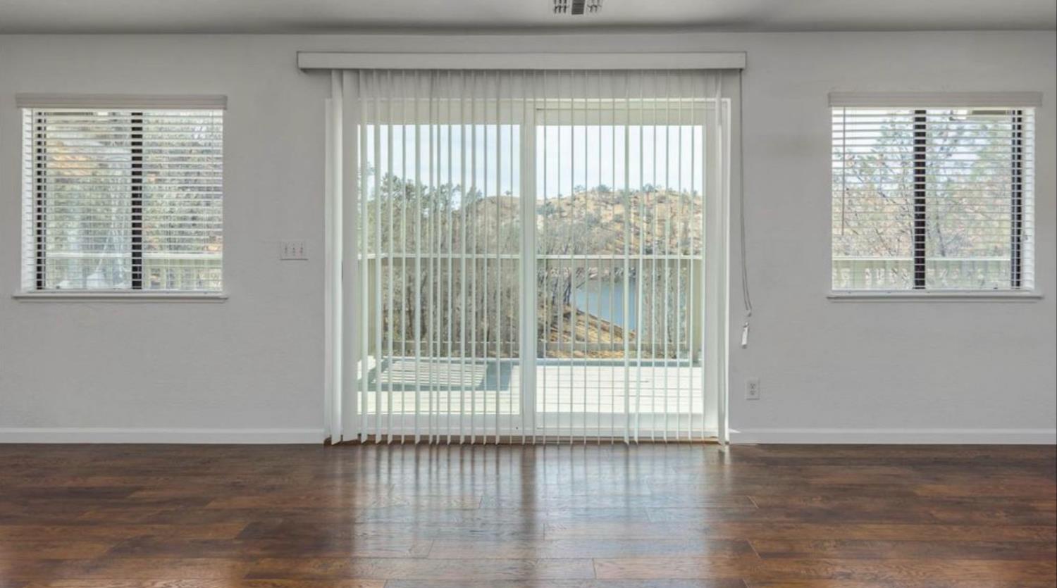 27817 Sky Harbour Road Friant, CA 93626 - Photo 14 of 36 a view of wooden floor and windows in a room