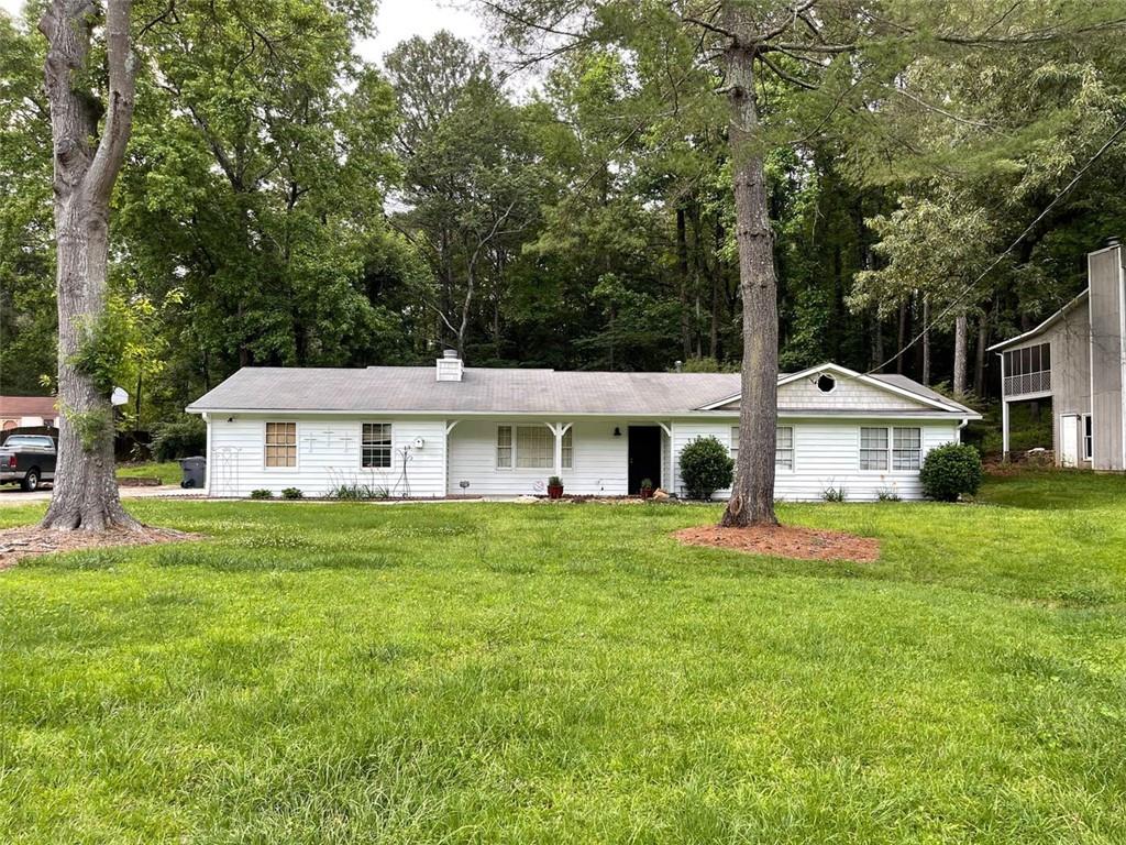 6250 Field Glen Road Stone Mountain, GA 30087 - Photo 1 of 1 a front view of a house with a yard and trees
