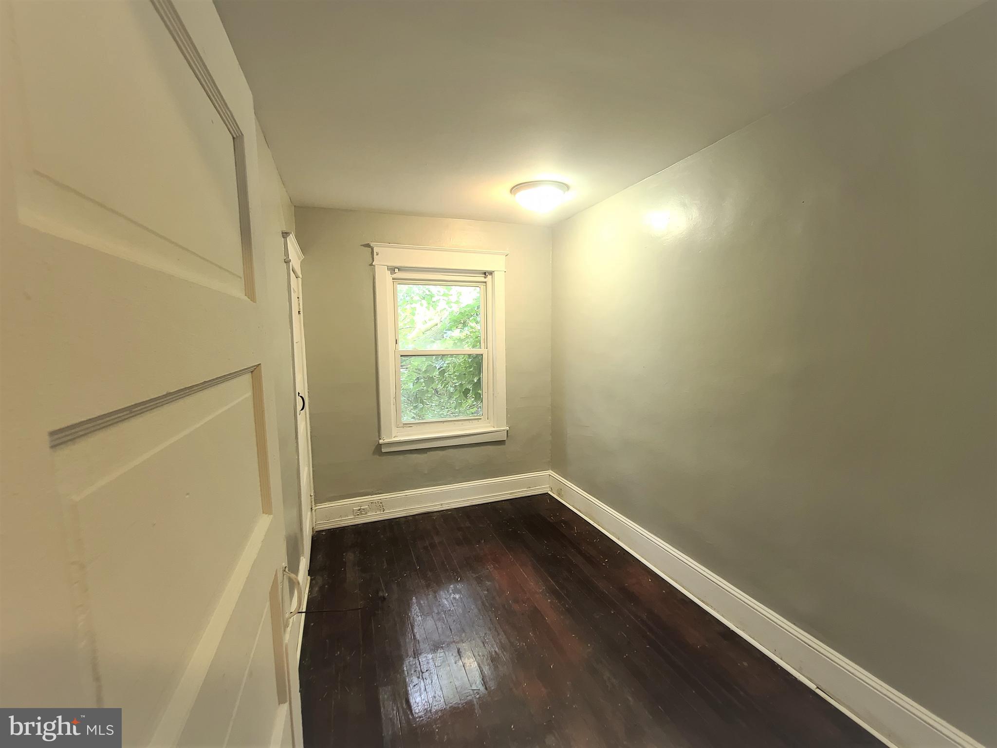 1008 McDowell Avenue Chester, PA 19013 - Photo 15 of 16 an empty room with wooden floor and windows