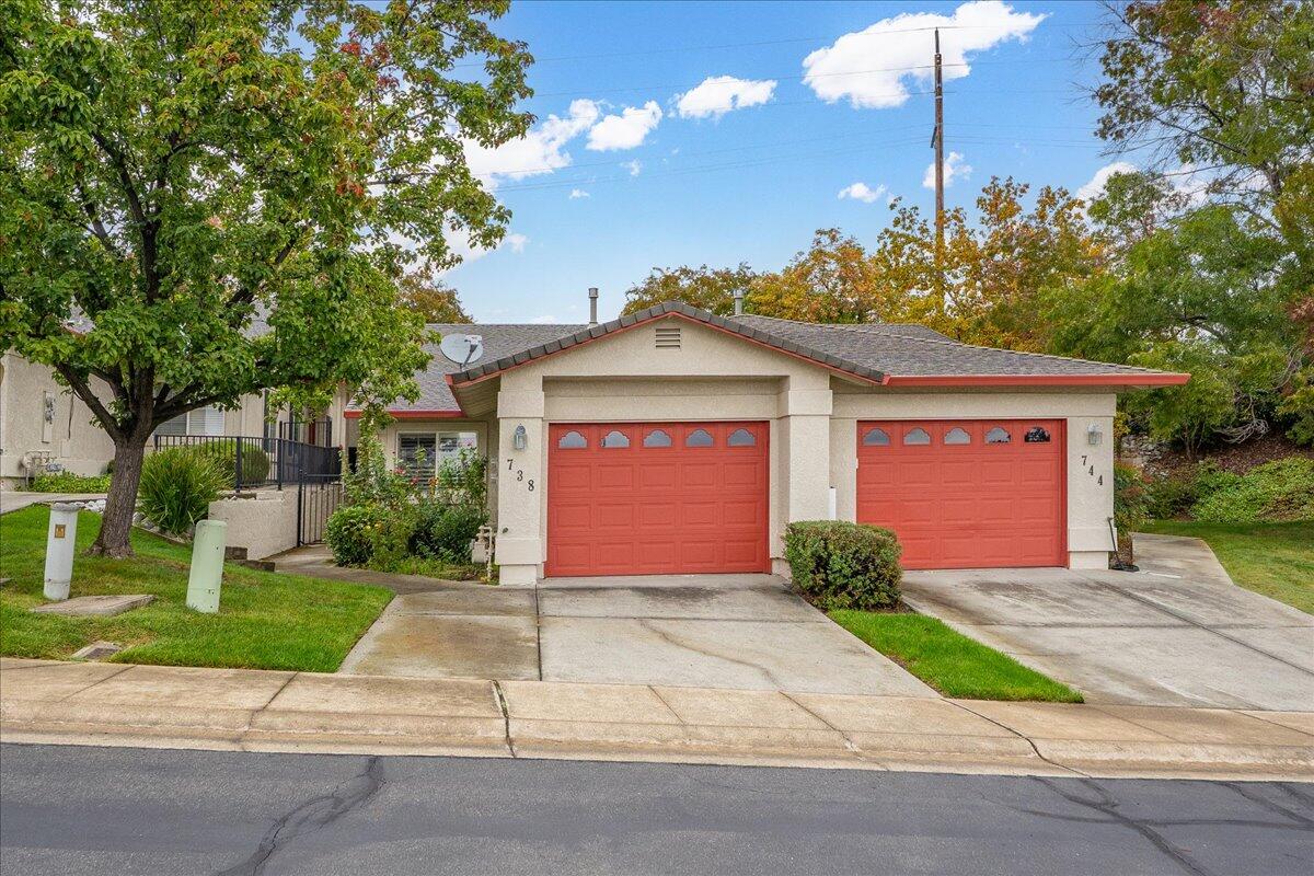 738 Stonebriar Trail Redding, CA 96003 - Photo 1 of 40 a front view of a house with a yard and potted plants