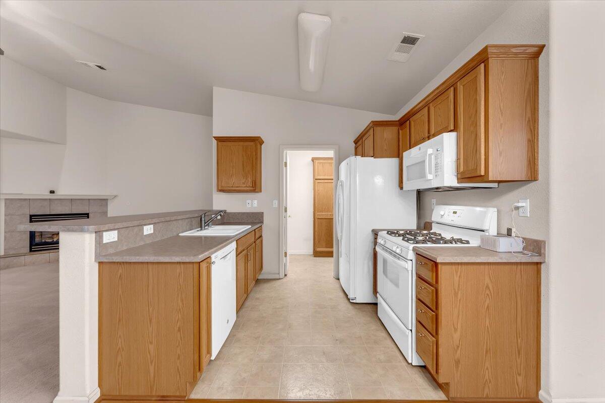738 Stonebriar Trail Redding, CA 96003 - Photo 11 of 40 a kitchen with a stove top oven sink and cabinets