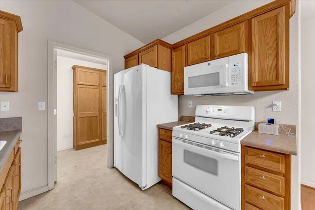 a kitchen with a stove cabinets and a refrigerator