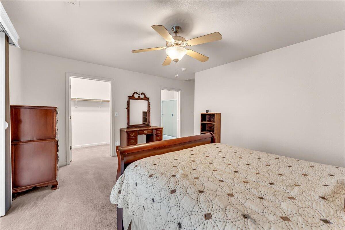 738 Stonebriar Trail Redding, CA 96003 - Photo 16 of 40 a bedroom with a bed and a refrigerator