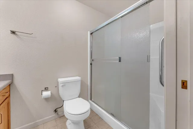 a white toilet sitting next to a bathroom sink and vanity