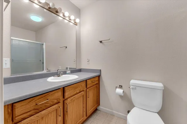 a bathroom with a toilet a sink and mirror