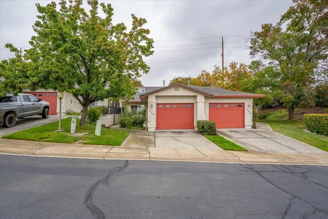 an aerial view of a house with a yard and lake view