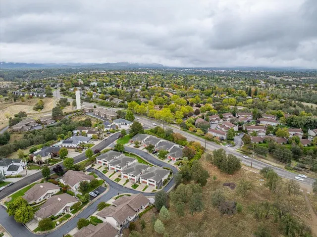 an aerial view of residential houses with outdoor space