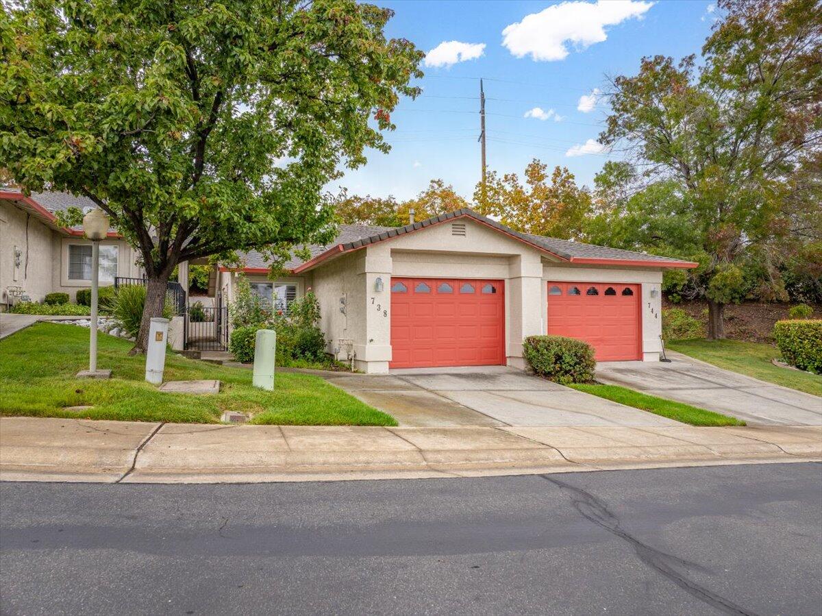 738 Stonebriar Trail Redding, CA 96003 - Photo 4 of 40 a view of a house with a yard and large tree