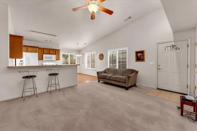 a living room with furniture and a chandelier