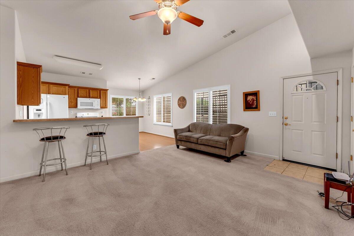 738 Stonebriar Trail Redding, CA 96003 - Photo 7 of 40 a living room with furniture and a chandelier
