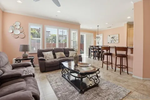 a living room with furniture wooden floor and a large window