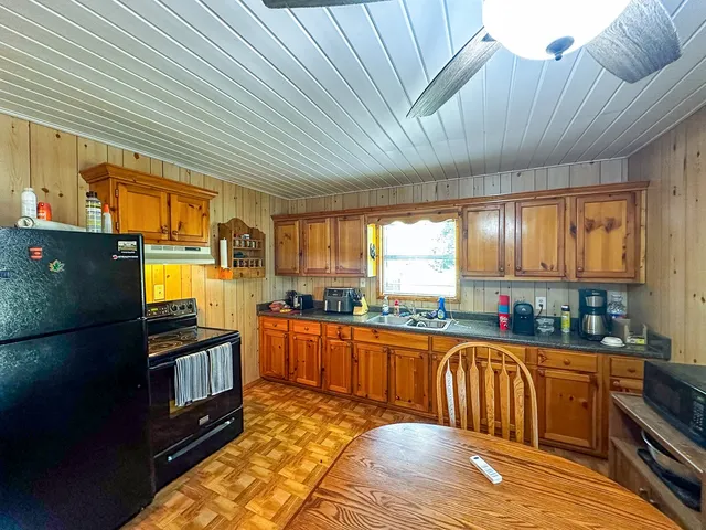 a kitchen with stainless steel appliances granite countertop a stove a refrigerator a sink and dishwasher