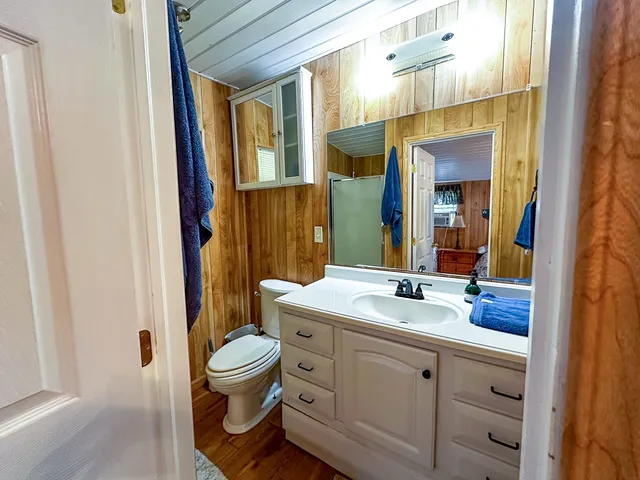 a spacious bathroom with a granite countertop toilet sink and a mirror