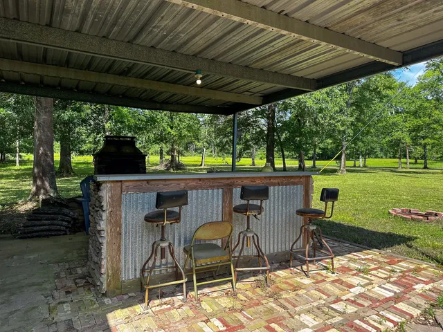 a view of a chairs and table in patio with a yard