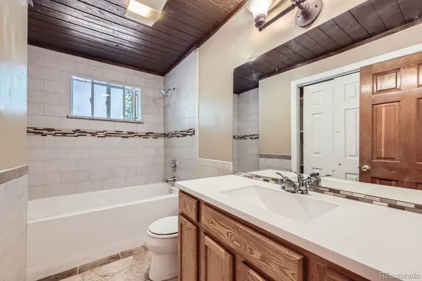 a bathroom with a sink a toilet and bathtub