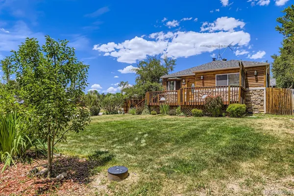 a view of a house with yard and a garden