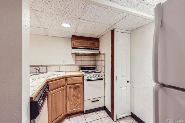 a kitchen with stainless steel appliances granite countertop a refrigerator and a stove