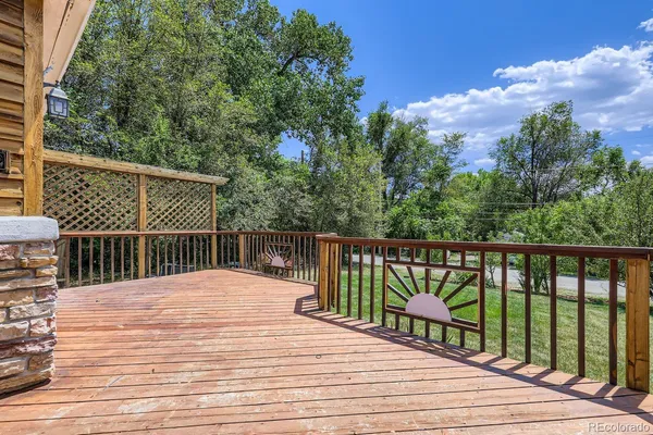 a balcony with wooden floor and fence