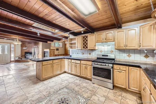 a kitchen with stainless steel appliances granite countertop a stove sink and cabinets