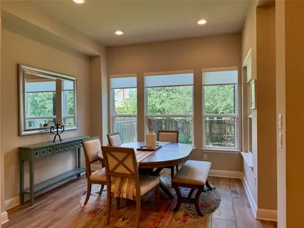 a dining room with furniture and wooden floor