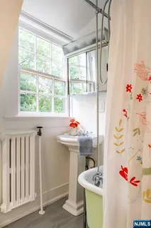a bathroom with a sink mirror toilet and bathtub