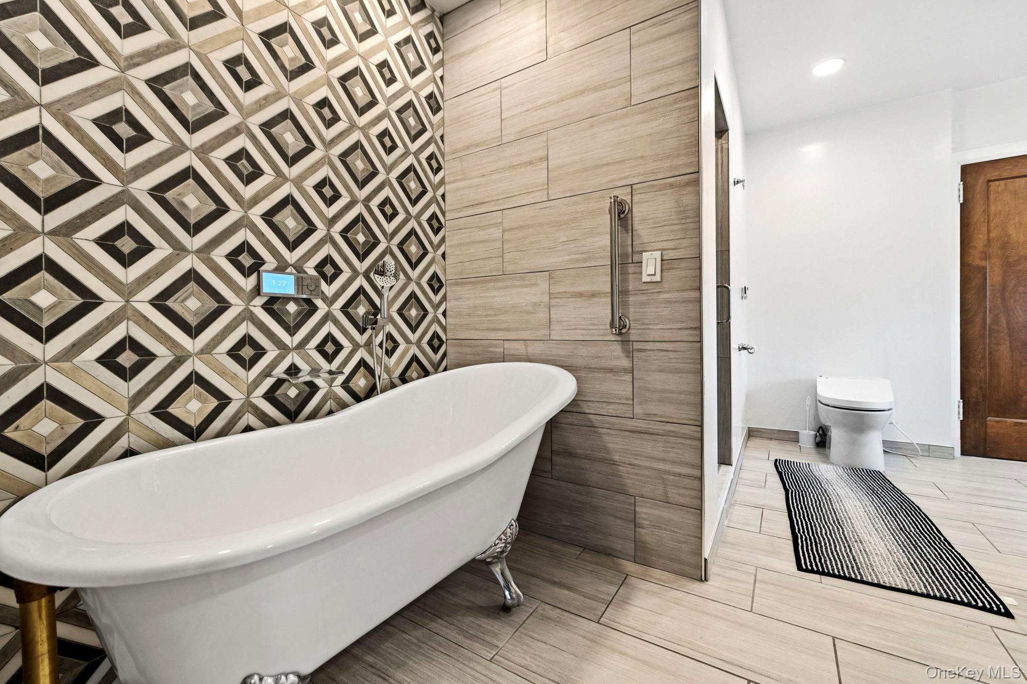 44 Fenimore Road New Rochelle, NY 10804 - Photo 21 of 46 a bathroom with a bathtub and a toilet