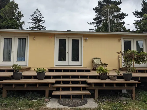 a view of a house with a chairs in patio