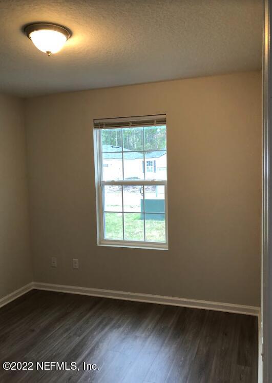 2209 Kistlers Rdg Way Jacksonville, FL 32221 - Photo 11 of 22 an empty room with wooden floor and windows