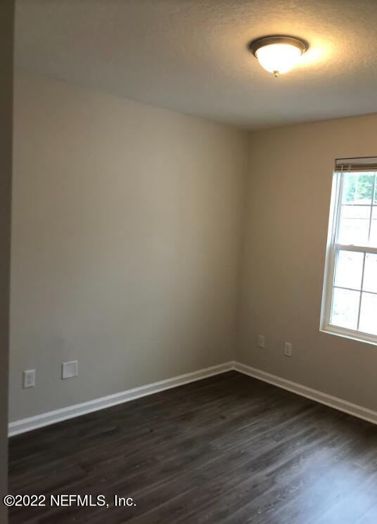 2209 Kistlers Rdg Way Jacksonville, FL 32221 - Photo 12 of 22 an empty room with wooden floor and windows