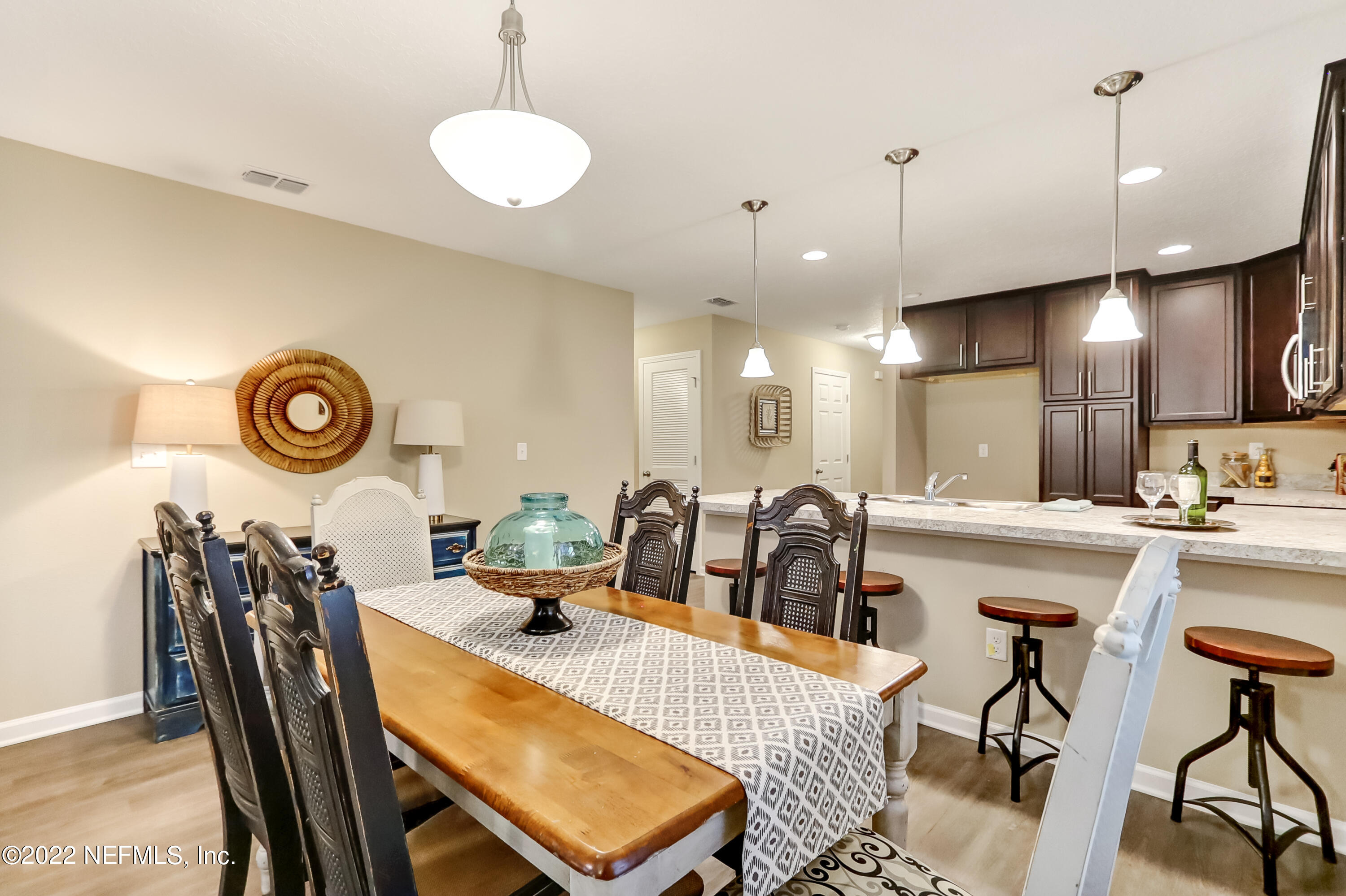 2209 Kistlers Rdg Way Jacksonville, FL 32221 - Photo 16 of 22 a kitchen with a dining table chairs and white cabinets