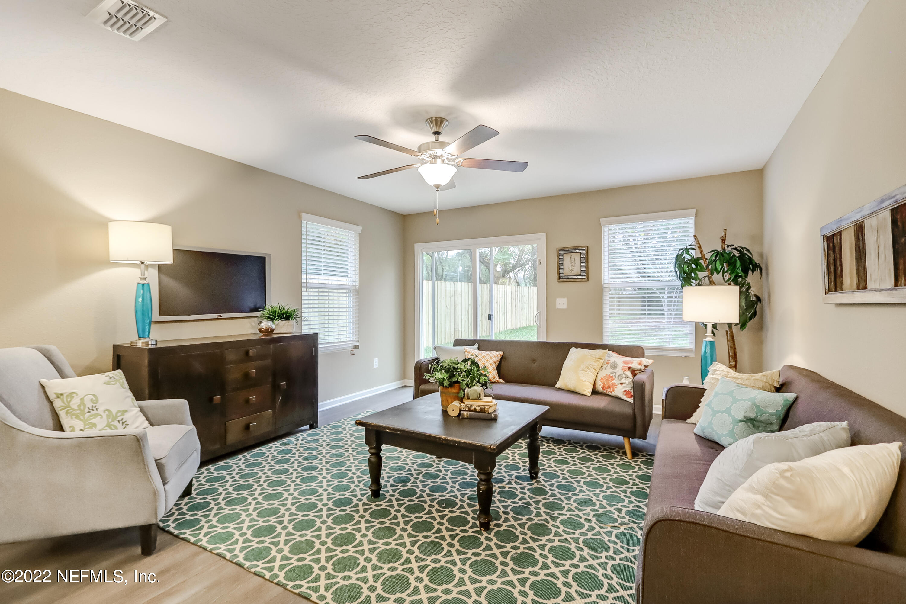 2209 Kistlers Rdg Way Jacksonville, FL 32221 - Photo 18 of 22 a living room with furniture a flat screen tv and a window