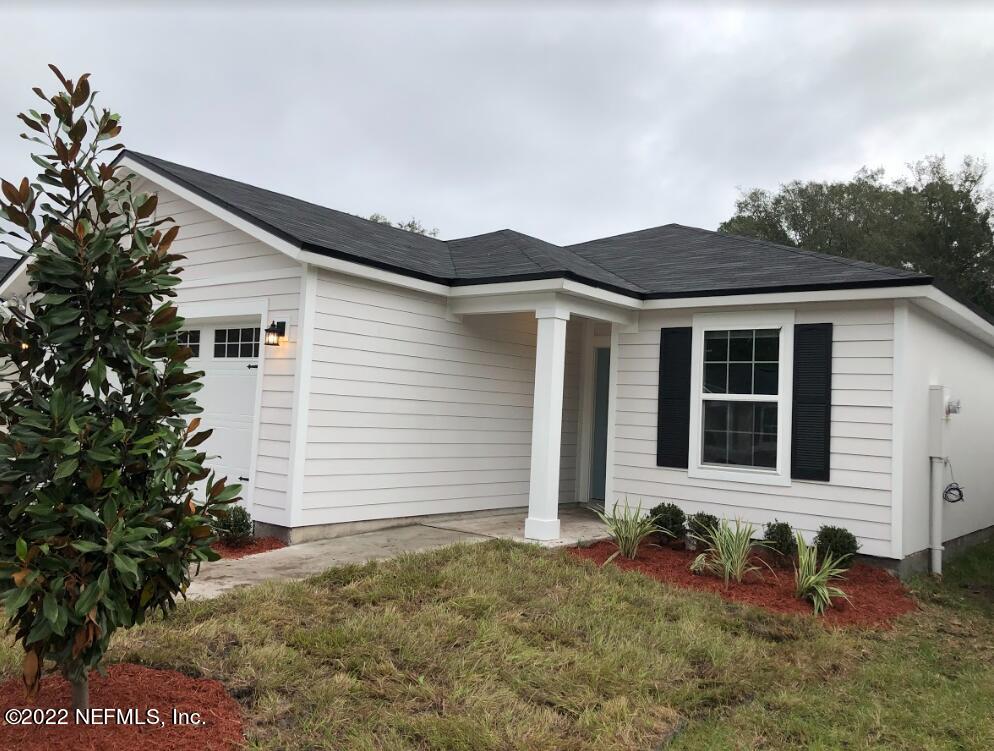 2209 Kistlers Rdg Way Jacksonville, FL 32221 - Photo 2 of 22 a front view of a house with garden