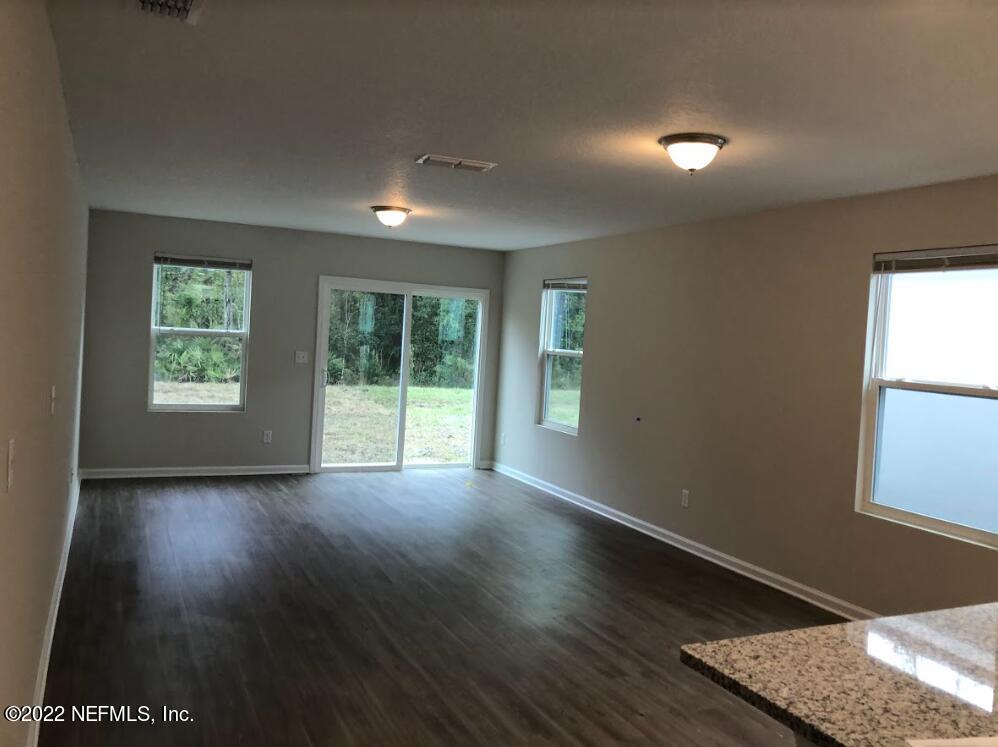2209 Kistlers Rdg Way Jacksonville, FL 32221 - Photo 4 of 22 an empty room with wooden floor and windows
