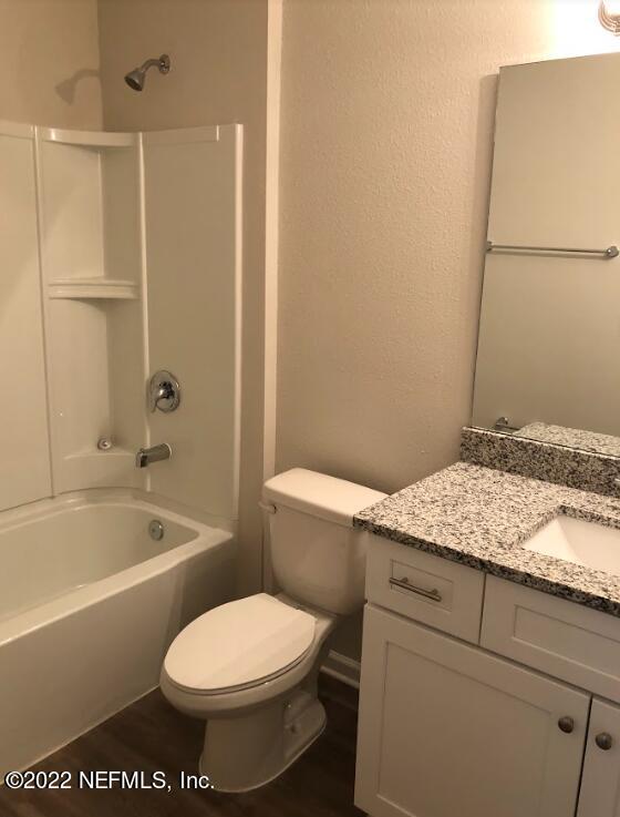 2209 Kistlers Rdg Way Jacksonville, FL 32221 - Photo 8 of 22 a bathroom with a granite countertop sink toilet and shower