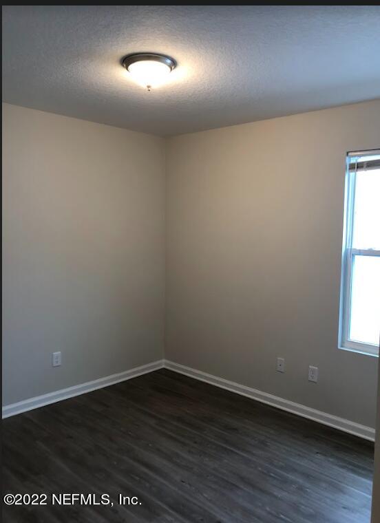 2209 Kistlers Rdg Way Jacksonville, FL 32221 - Photo 9 of 22 an empty room with wooden floor and windows