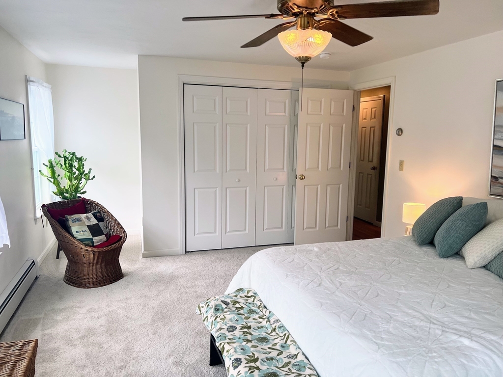 11 Valley View Circle Rutland, MA 01543 - Photo 22 of 38 a bedroom with a bed and a chandelier