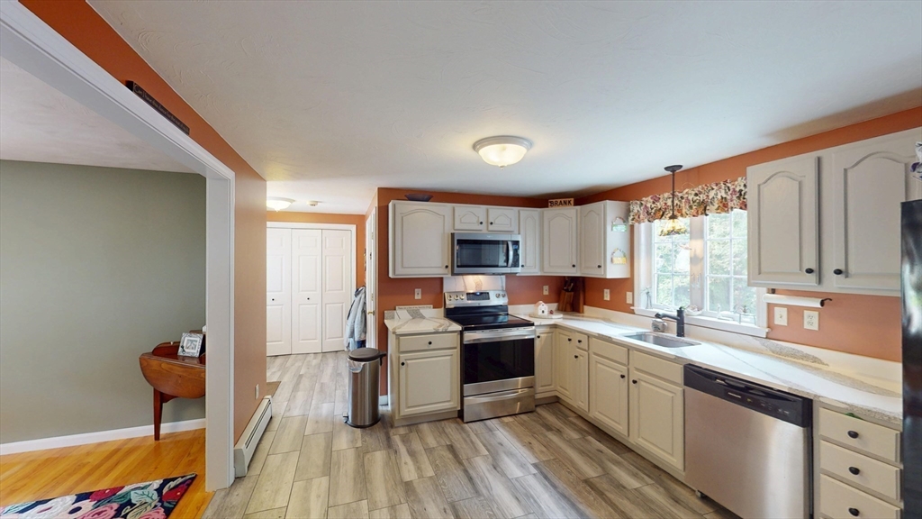 11 Valley View Circle Rutland, MA 01543 - Photo 8 of 38 a kitchen with a sink a counter top space stainless steel appliances and cabinets