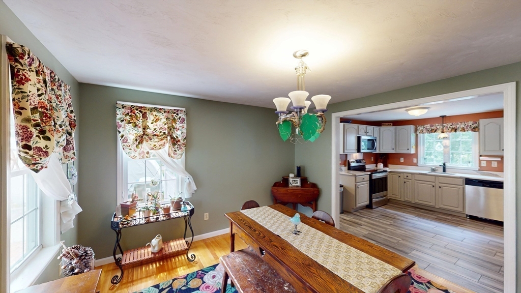 11 Valley View Circle Rutland, MA 01543 - Photo 10 of 38 a living room with dining table furniture and a chandelier