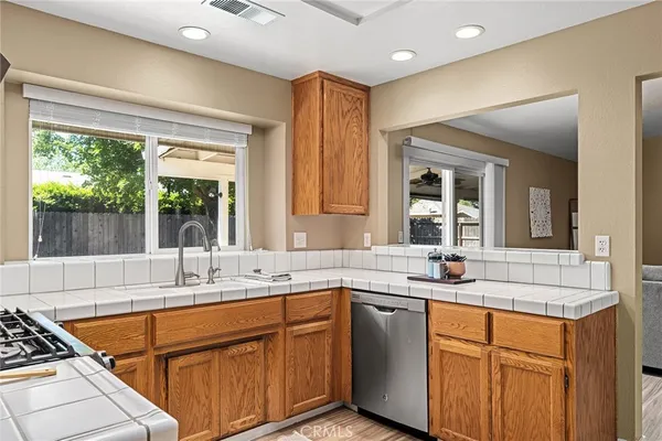 a kitchen with stainless steel appliances granite countertop a sink stove and cabinets