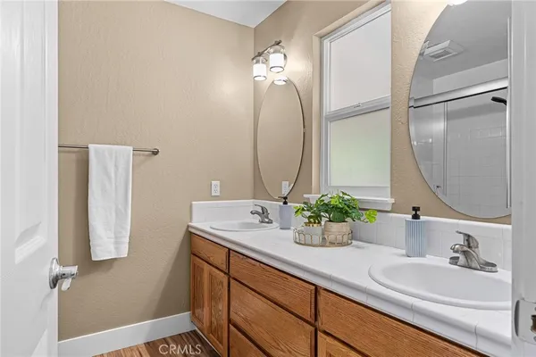 a bathroom with a double vanity sink and a mirror