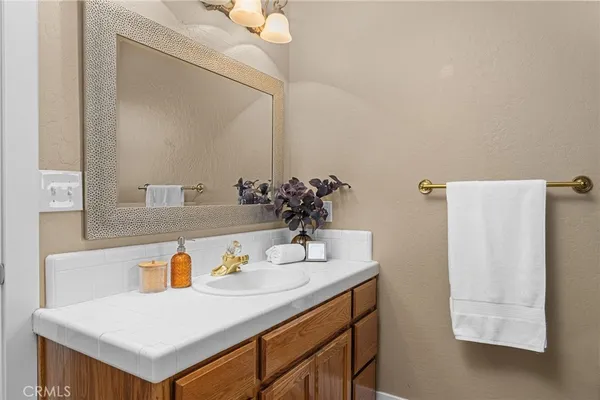 a bathroom with a sink vanity and a mirror