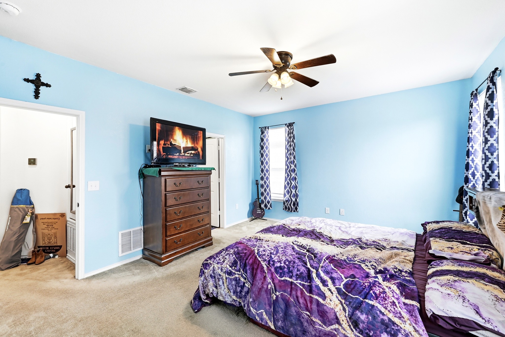 1621 Dragonfly Loop Bastrop, TX 78602 - Photo 16 of 27 Carpeted room with light blue walls and a ceiling fan
