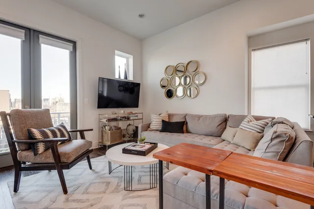 a living room with furniture and a flat screen tv