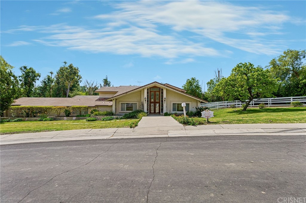 24862 Eldorado Meadow Road Hidden Hills, CA 91302 - Photo 1 of 16 a front view of a house with a yard and potted plants